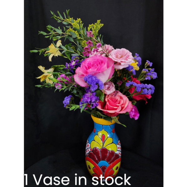 Colorful mixed flower arrangement in a painted vase
