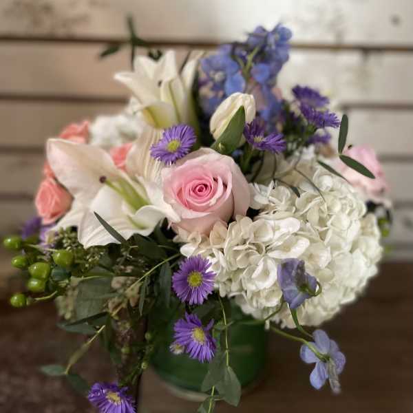 Mixed bouquet with pink roses, white lilies, and purple flowers