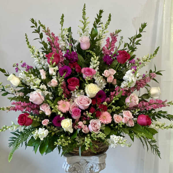 Large basket arrangement of pink, white, and magenta flowers
