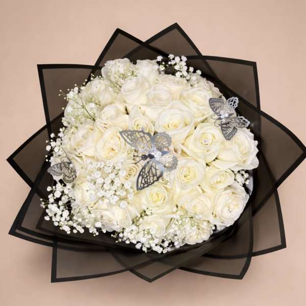 Round bouquet of ivory roses with baby's breath and silver butterflies in black wrap