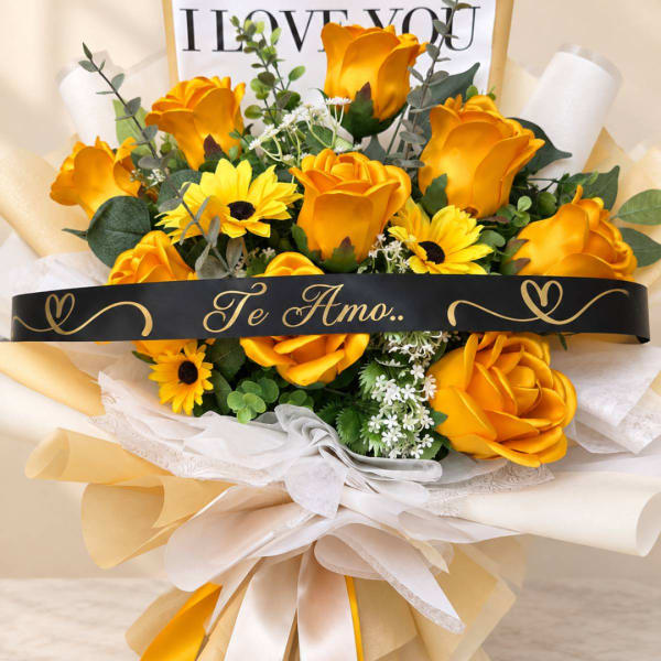 Yellow rose bouquet with sunflowers and a black "Te Amo" ribbon