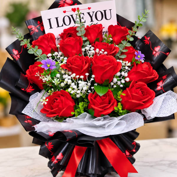 Bouquet of red roses with a card reading I LOVE YOU