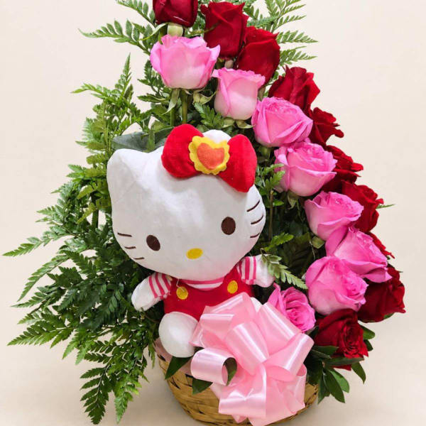 Basket arrangement with pink and red roses and a Hello Kitty plush
