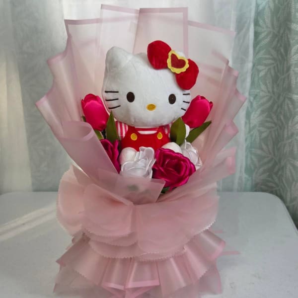 Hello Kitty plush bouquet with pink and white flowers wrapped in pink paper