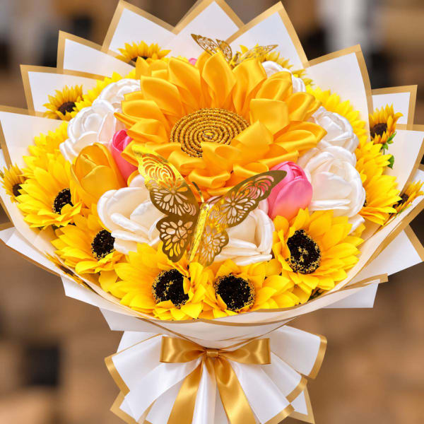 Bouquet of yellow sunflowers and white satin flowers with gold ribbon