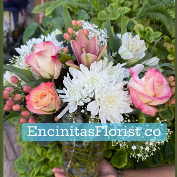 Pink roses and white chrysanthemums in a glass vase