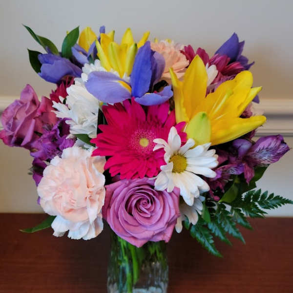Colorful mixed bouquet in a clear glass vase