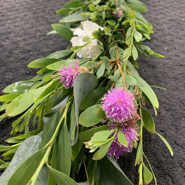 Long floral garland with white roses and pink pom-pom blooms