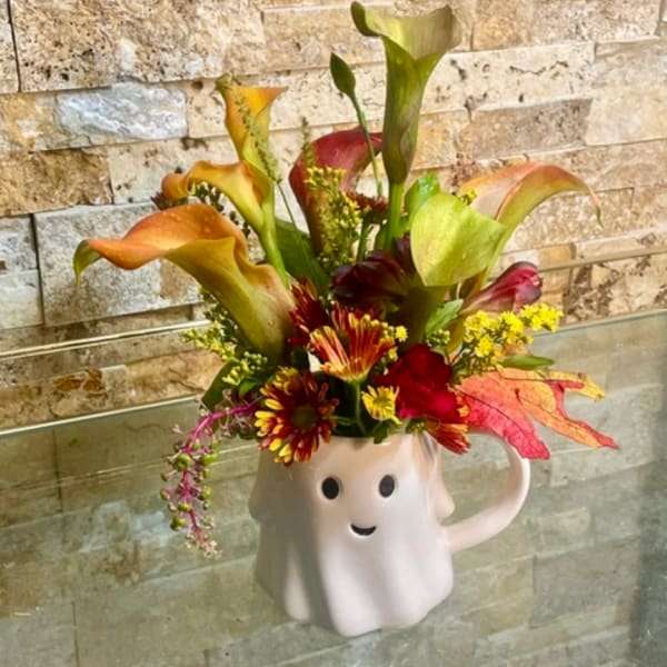 Fall floral arrangement in a white ghost mug vase