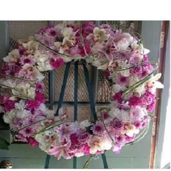Pink and white floral wreath on a stand