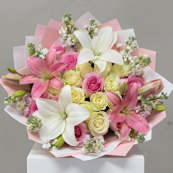 Bouquet of pink and white lilies with pink and pale yellow roses