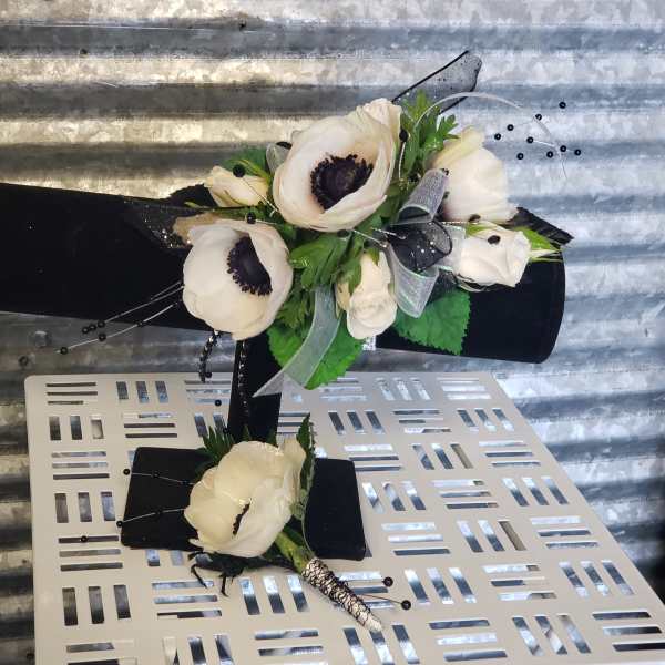 White anemone bouquet with black ribbon and silver accents