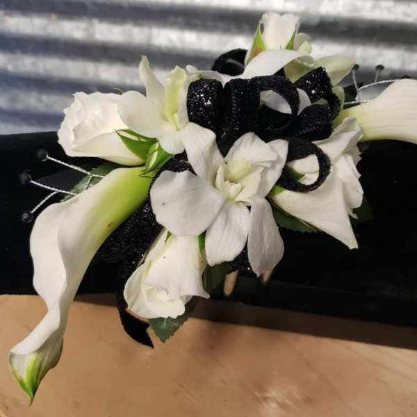 White calla lilies and orchids with a black ribbon