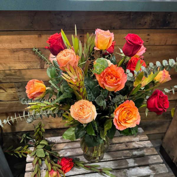Mixed roses in a glass vase with eucalyptus