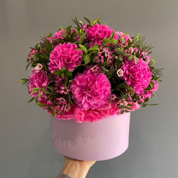 Pink carnation bouquet in a round pink box