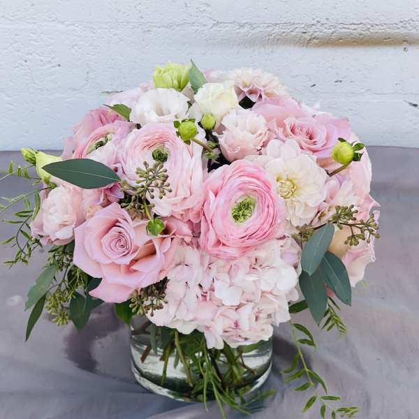 Pink and white bouquet in a clear glass vase