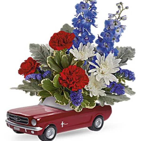 Floral arrangement in a red car-shaped container