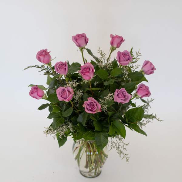 Pink roses arranged in a clear glass vase