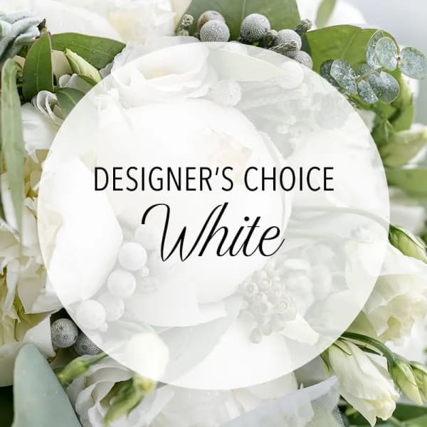 White floral arrangement with green foliage and a "Designer’s Choice White" label