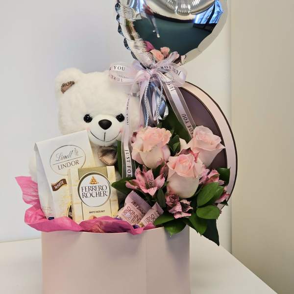 Beautiful arrangement with bear and chocolates