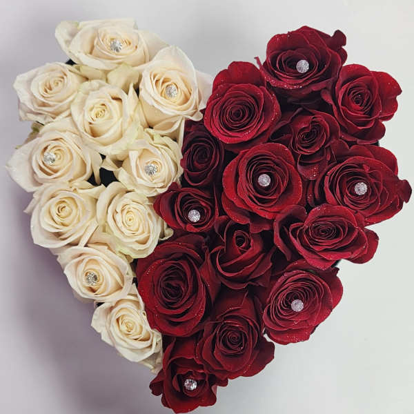 Heart-shaped arrangement of cream and red roses with jeweled centers