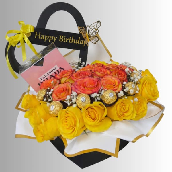 Birthday gift bouquet with yellow and orange roses, chocolates, and a card