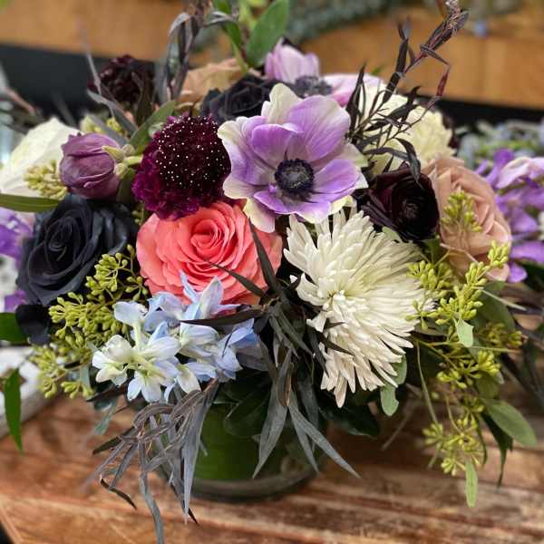 Mixed bouquet with roses, anemones, and chrysanthemums in a vase