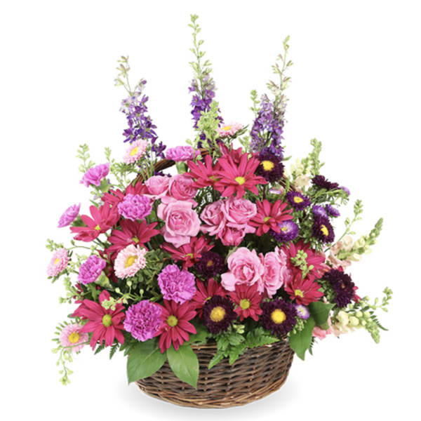 Basket arrangement of pink and purple mixed flowers