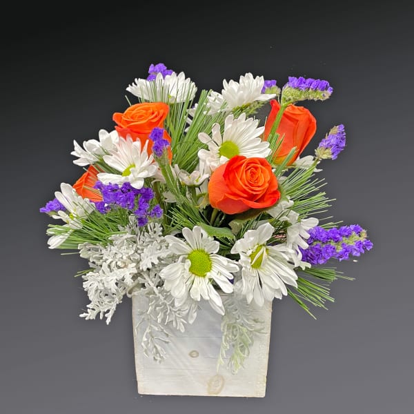 Orange roses and white daisies in a white wooden box