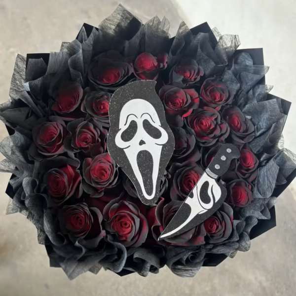 Bouquet of dark red roses with black wrapping and horror-movie face cutouts