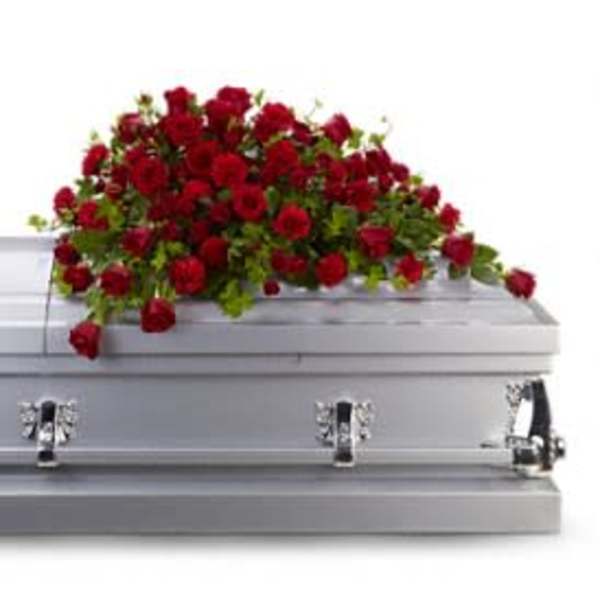 Red rose spray on a silver casket