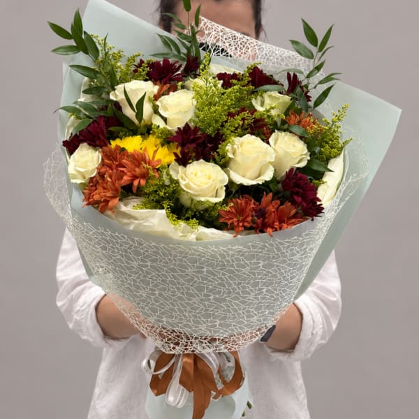 Bouquet of white roses, burgundy and orange chrysanthemums, and yellow filler flowers