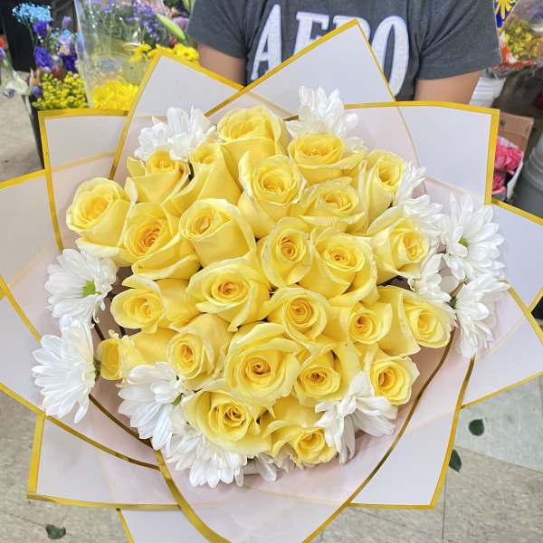 Yellow rose bouquet with white daisies wrapped in white paper