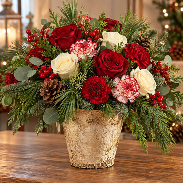 Red and white roses with carnations in a gold vase