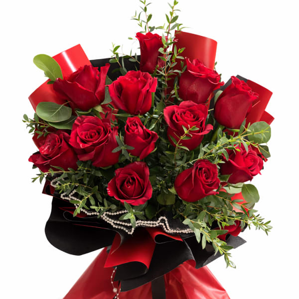 Bouquet of red roses with greenery wrapped in black and red paper