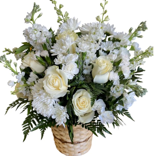 White roses and chrysanthemums arranged in a woven basket