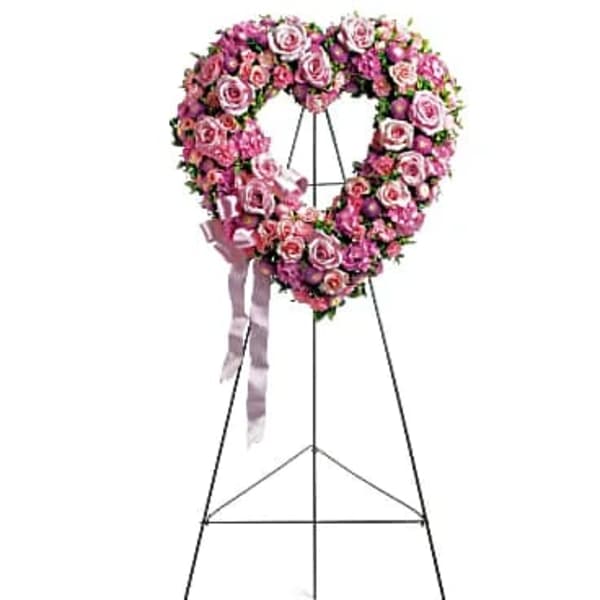Pink rose heart-shaped standing floral wreath on an easel