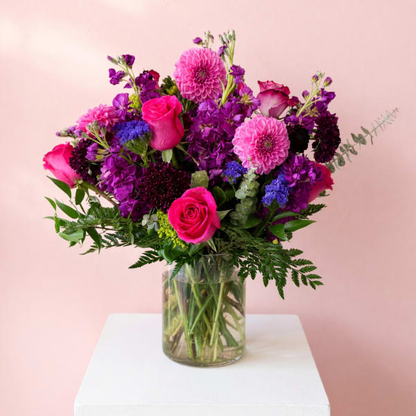Pink and purple mixed bouquet in a glass vase