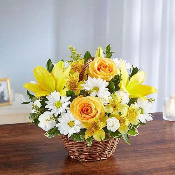 Yellow and white flower arrangement in a wicker basket