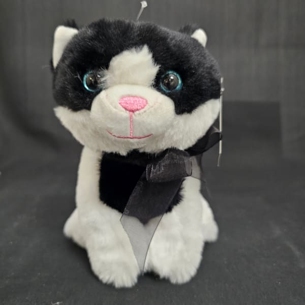 Black and white plush cat with a ribbon bow