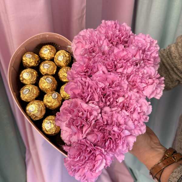 Pink carnation bouquet with gold-wrapped chocolates in a heart-shaped box