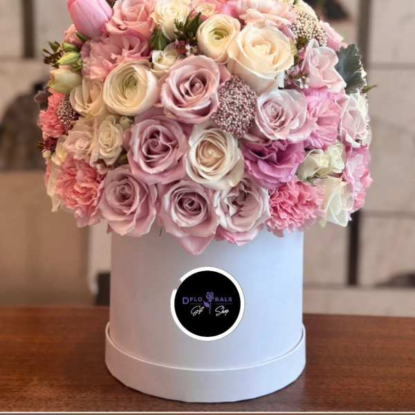 Pink and cream rose bouquet in a white hat box