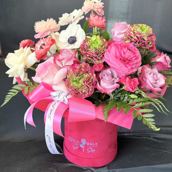 Pink and white mixed bouquet in a bright pink hat box with ribbon