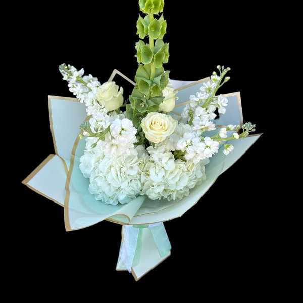 White bouquet with roses, hydrangeas, and a tall green spike