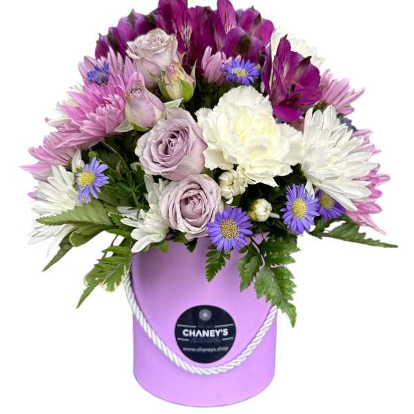 Lavender and white bouquet in a purple hatbox