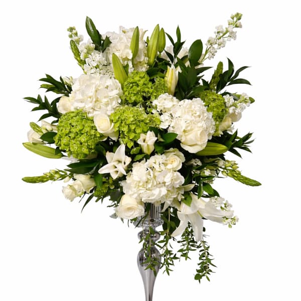 White floral arrangement in a tall silver vase
