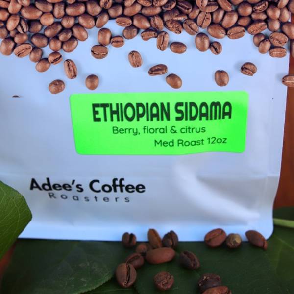 Bag of Ethiopian Sidama coffee beans with beans scattered around it