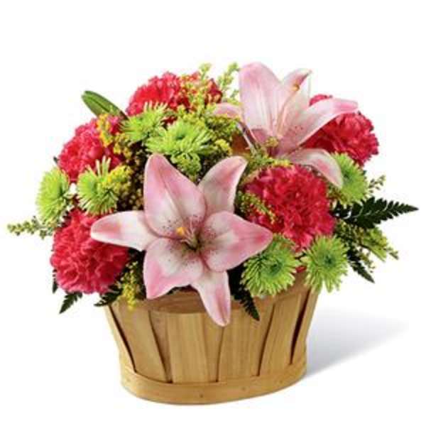 Pink lilies and red carnations in a wooden basket