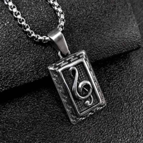Silver music note pendant necklace on black fabric