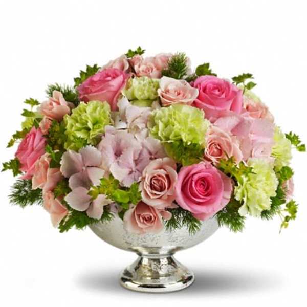 Pink and blush roses arranged in a silver pedestal vase